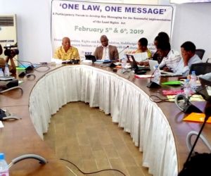 lla commissioner cllr kula l jackson and executive director at the head of the table making remarks at the land rights act messaging workshop held in monrovia