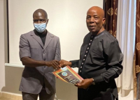 L-R: Dr. Emmanuel Urey Yarkpawolo presenting the certificate of honor to LLA Executive Director, Mr. Stanley N. Toe